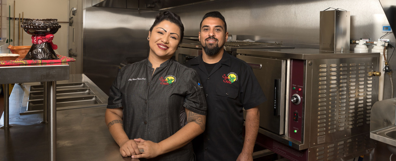 Chef Maria Parra Cano and husband Brian Cano in the kitchen at the Phoenix Indian School Visitor Center.