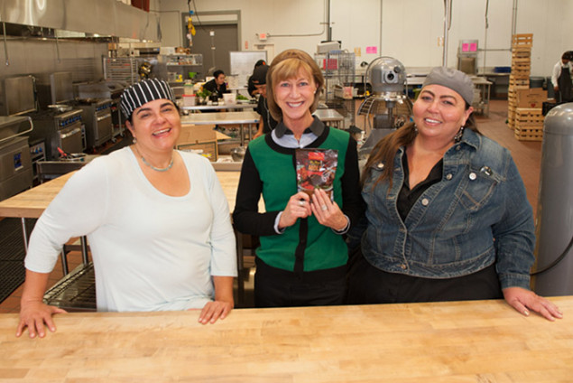 Kelly Smith, Director of Marketing and Social Media at Santa Cruz Community Credit Union, visits the kitchen, pictured with Carmen Herrera-Mansir and Amy Mascareñas